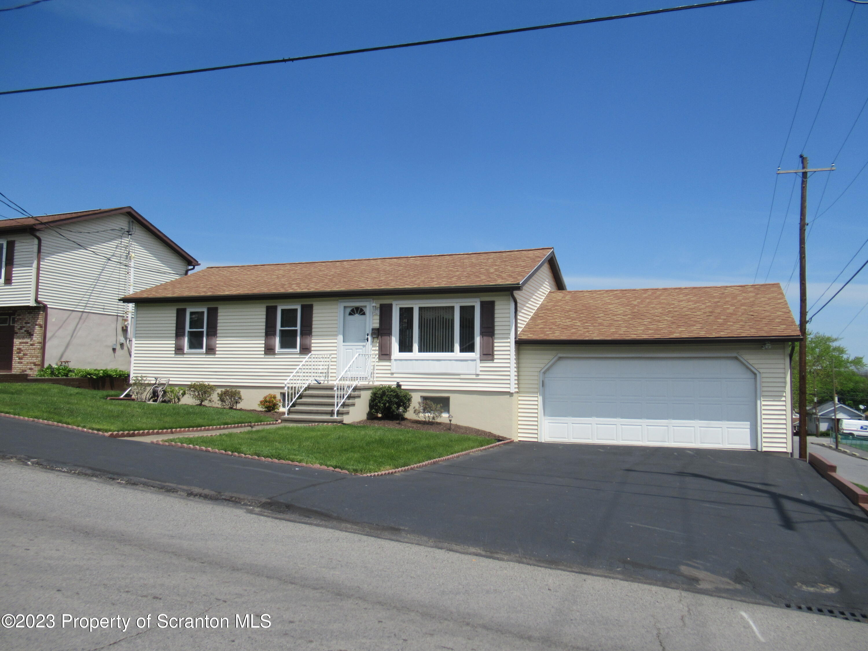 602 Eynon Street Scranton, PA 18504 - Photo 67 of 80 a front view of a house with a yard and garage