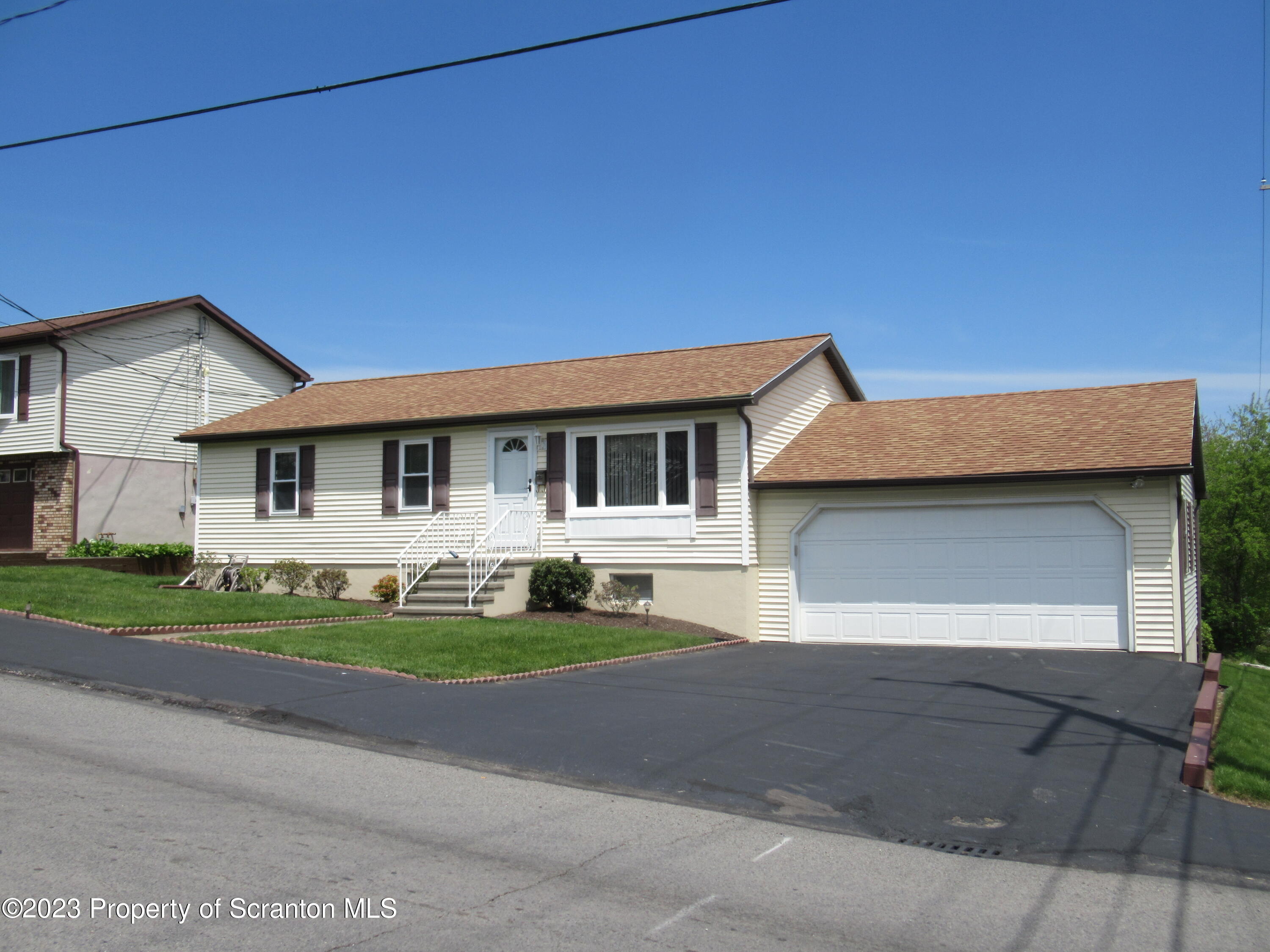 602 Eynon Street Scranton, PA 18504 - Photo 68 of 80 a front view of a house with a yard and garage