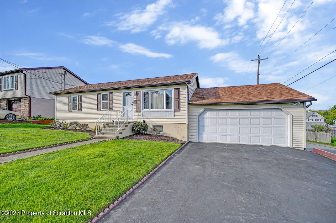 602 Eynon Street Scranton, PA 18504 - Photo 9 of 80 a front view of a house with a yard and garage