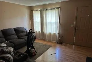 a living room with furniture and a gate