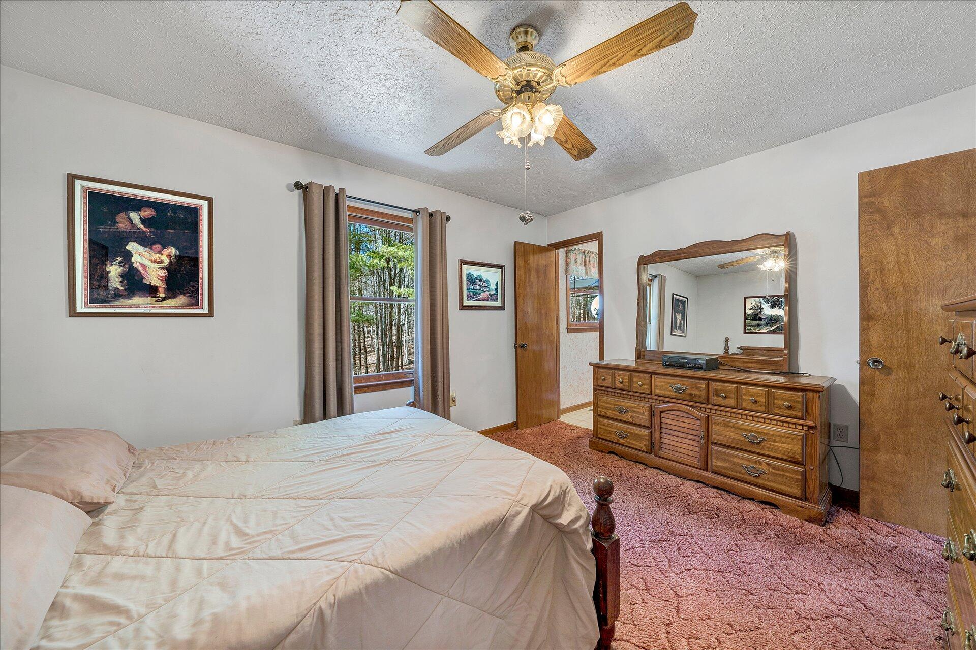 98 Sunset Ridge Road Callaway, VA 24067 - Photo 16 of 32 a bedroom with a bed and a dresser