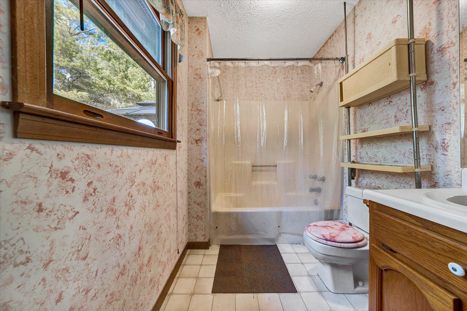98 Sunset Ridge Road Callaway, VA 24067 - Photo 17 of 32 a bathroom with a granite countertop bathtub shower sink mirror vanity and toilet