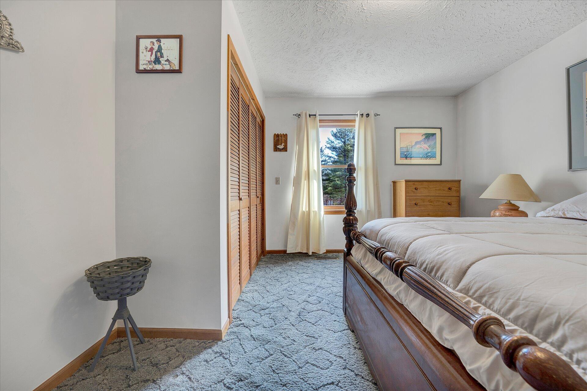 98 Sunset Ridge Road Callaway, VA 24067 - Photo 18 of 32 a bedroom with a bed and a lamp