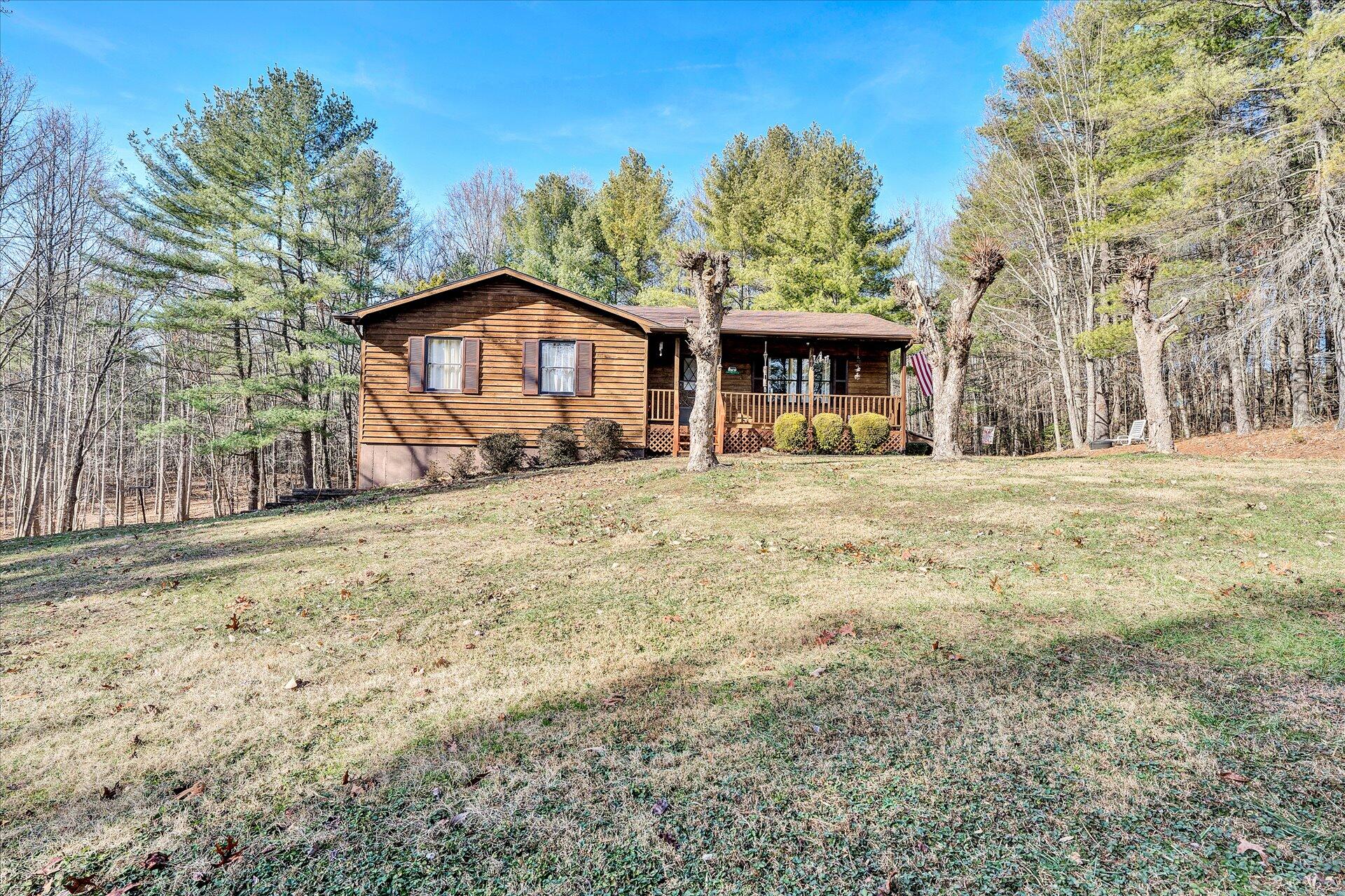 98 Sunset Ridge Road Callaway, VA 24067 - Photo 30 of 32 a big house with large trees and wooden fence