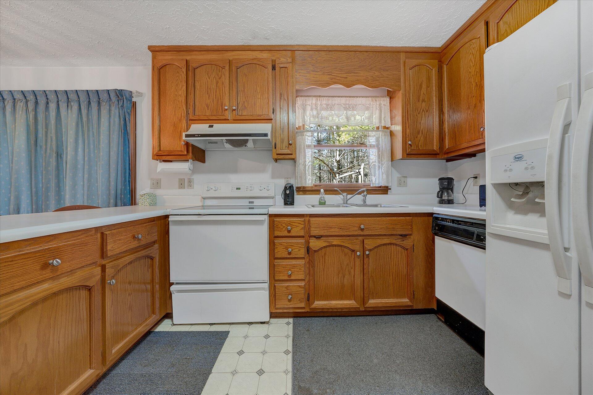 98 Sunset Ridge Road Callaway, VA 24067 - Photo 10 of 32 a kitchen with stainless steel appliances granite countertop a sink stove and cabinets