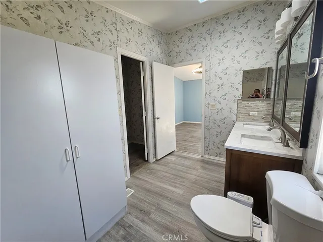 a bathroom with a toilet mirror and vanity