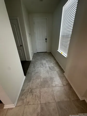 a view of a hallway to rooms