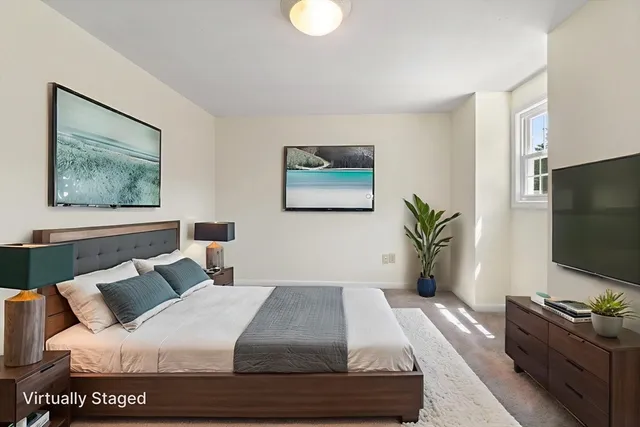 a bedroom with a bed and a flat screen tv