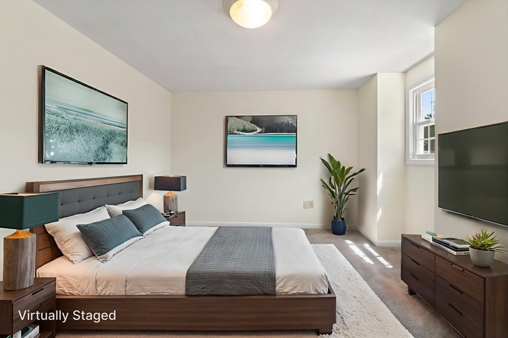 23 Constitution Way, Unit 23 Methuen, MA 01844 - Photo 11 of 21 a bedroom with a bed and a flat screen tv