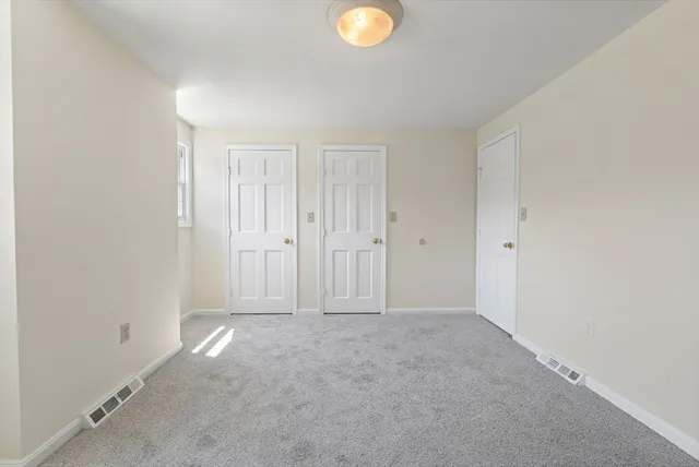 an empty room with closet area