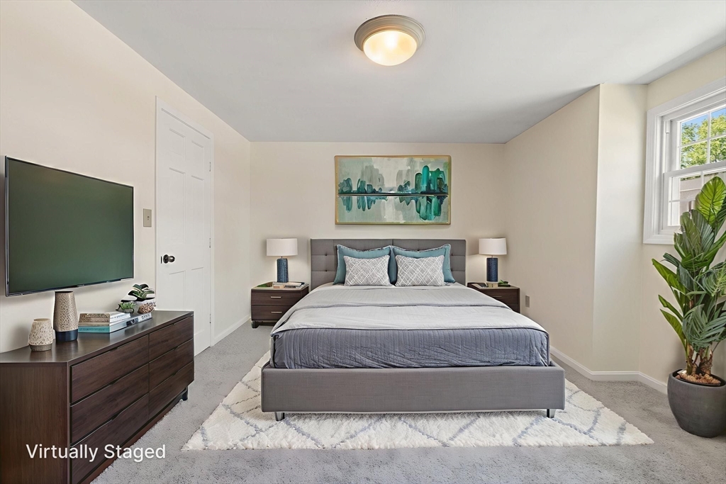 23 Constitution Way, Unit 23 Methuen, MA 01844 - Photo 16 of 21 a bedroom with a bed and a flat screen tv