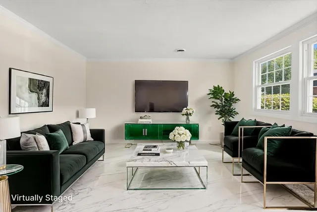 a living room with furniture a large window and a flat screen tv