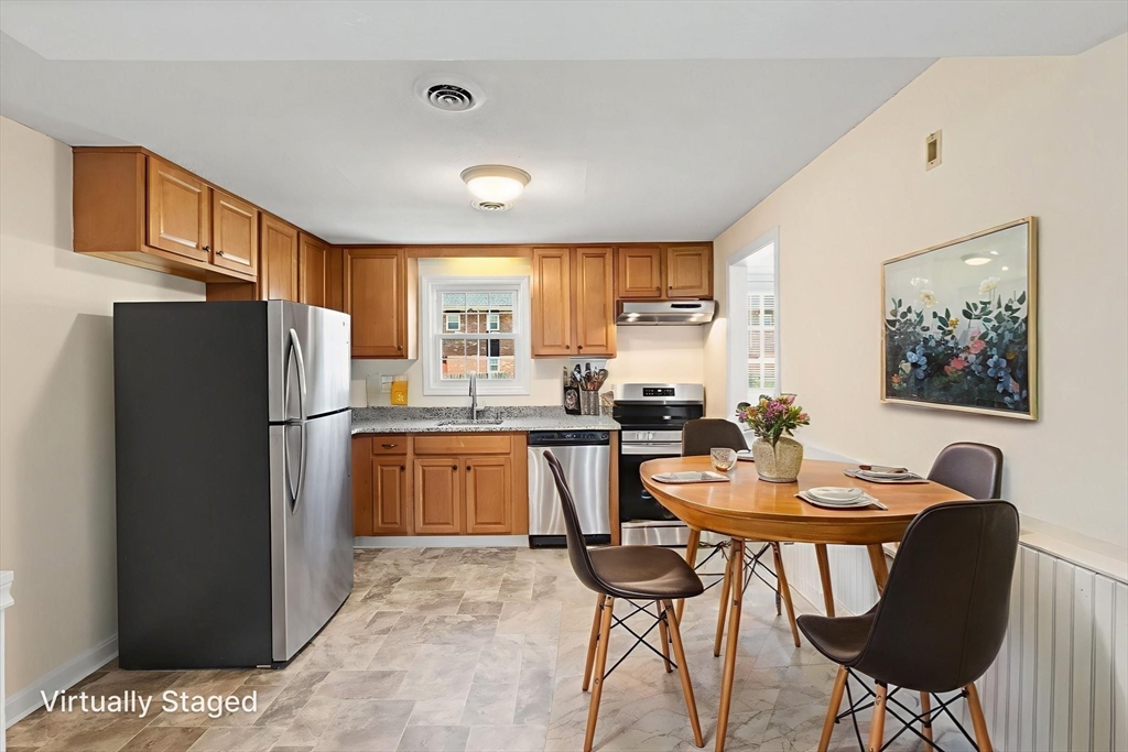 23 Constitution Way, Unit 23 Methuen, MA 01844 - Photo 6 of 21 a kitchen with a refrigerator a stove a dining table and chairs
