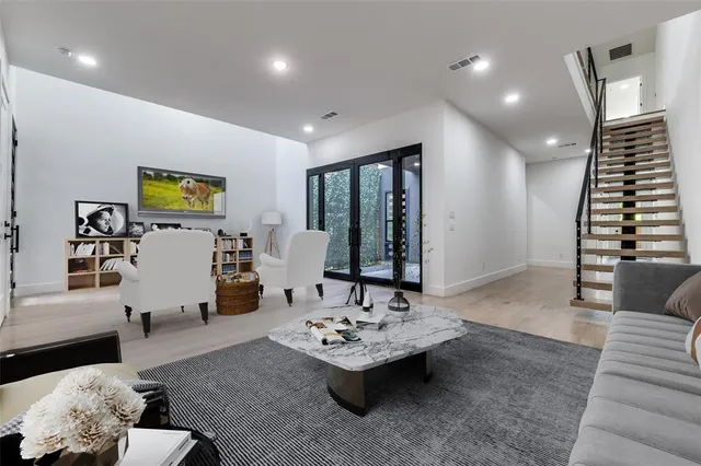 a living room with furniture and wooden floor