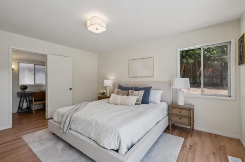 a bedroom with a bed and a large window