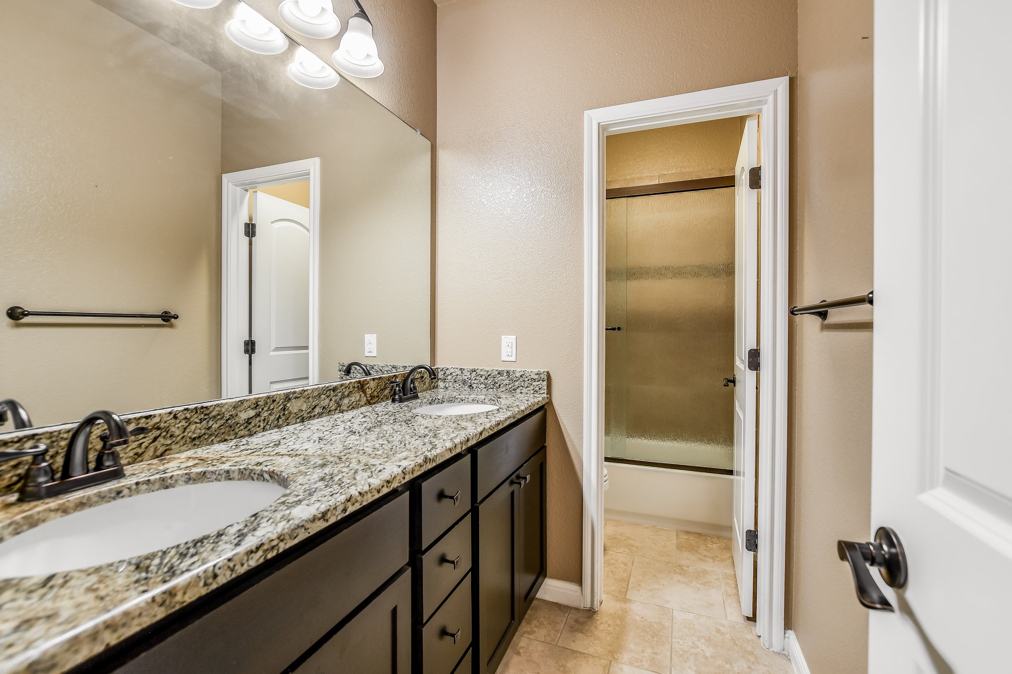 2037 Tribal Way Leander, TX 78641 - Photo 12 of 14 This luxurious hall bath has a double vanity, granite counters, and drawers