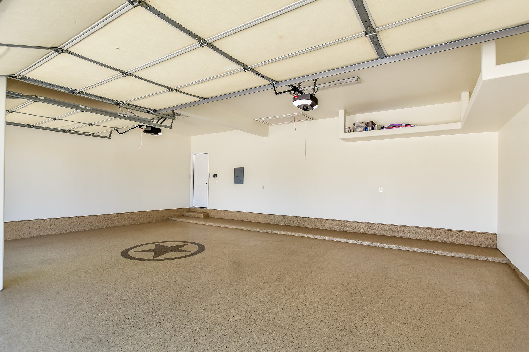 2037 Tribal Way Leander, TX 78641 - Photo 14 of 14 This three-car garage has epoxy floors and built-in storage