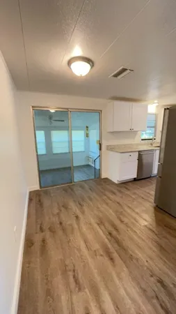 a room with a bed and cabinets