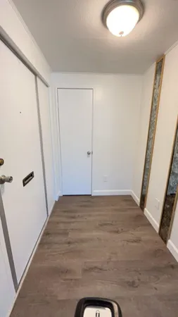 a view of a room with wooden floor and white doors