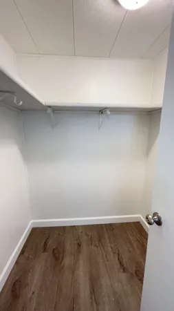 a view of a room with wooden floor