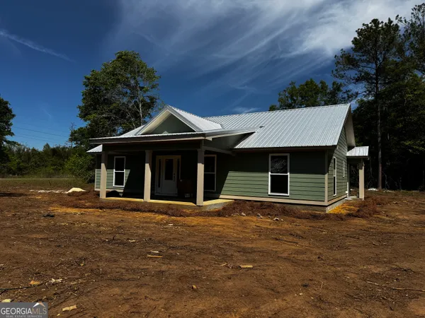 a house that has a tree in front of it