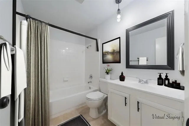 a bathroom with a toilet sink a shower and a mirror