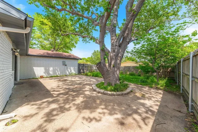 a view of a house with a tree in the background