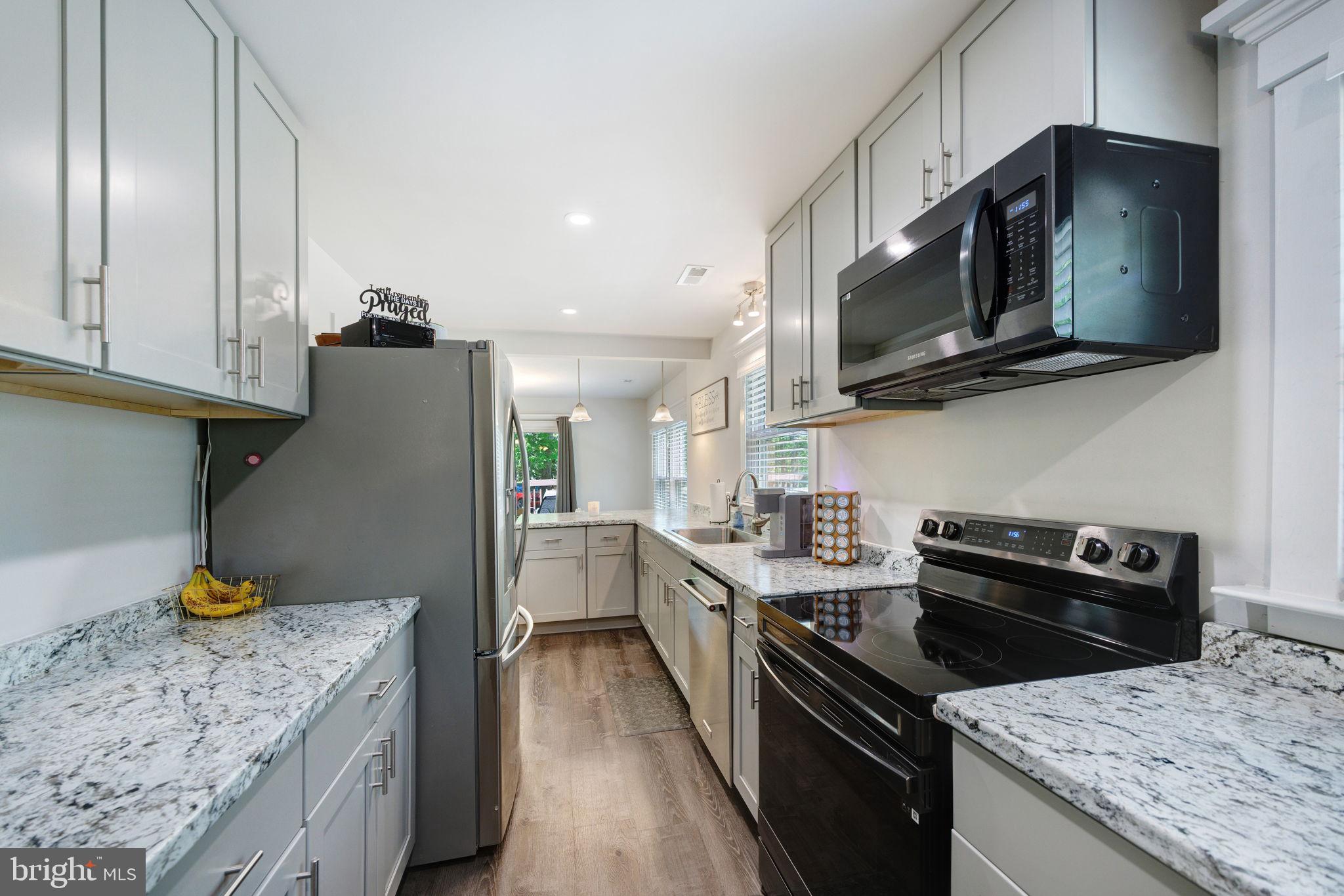 919 Chalklevel Road Louisa, VA 23093 - Photo 11 of 32 a kitchen with stainless steel appliances granite countertop a sink stove and refrigerator