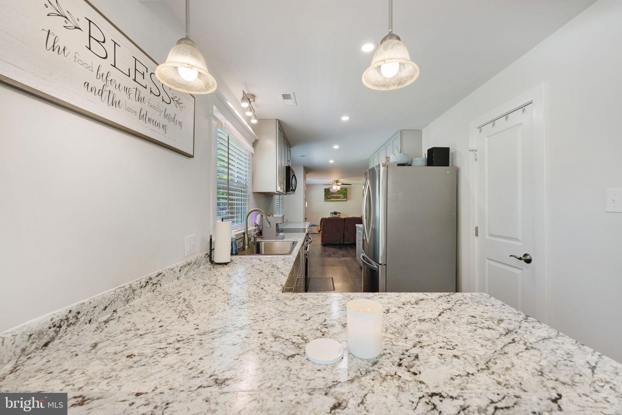 919 Chalklevel Road Louisa, VA 23093 - Photo 13 of 32 a kitchen with a refrigerator and a wooden floor