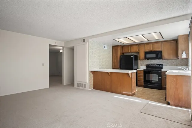 a view of kitchen with refrigerator sink and stove