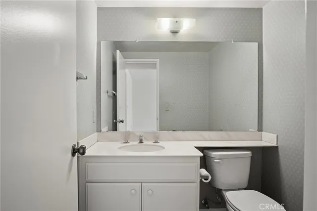 a bathroom with a sink toilet and mirror