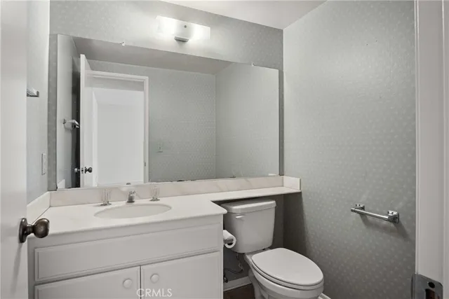 a bathroom with a sink a toilet and mirror