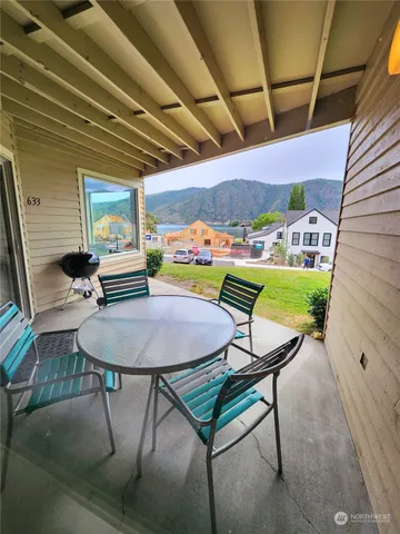 a balcony with table and chairs