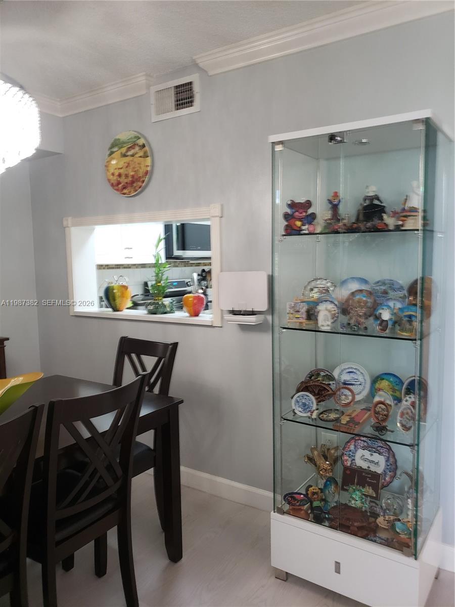 11800 Southwest 18th Street, Unit 3274 Miami, FL 33175 - Photo 17 of 23 a dining room filled with lots of furniture and kitchen view