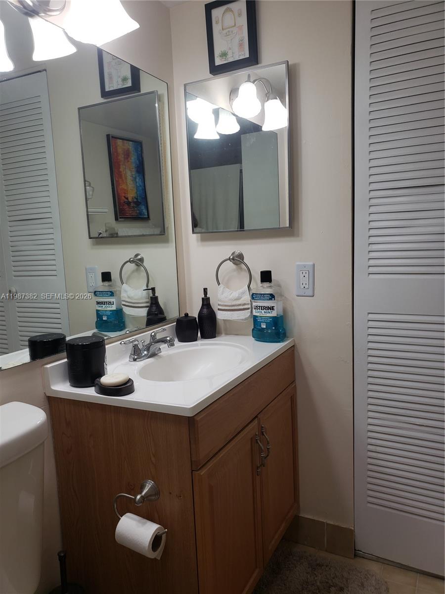 11800 Southwest 18th Street, Unit 3274 Miami, FL 33175 - Photo 21 of 23 a bathroom with a sink and a mirror