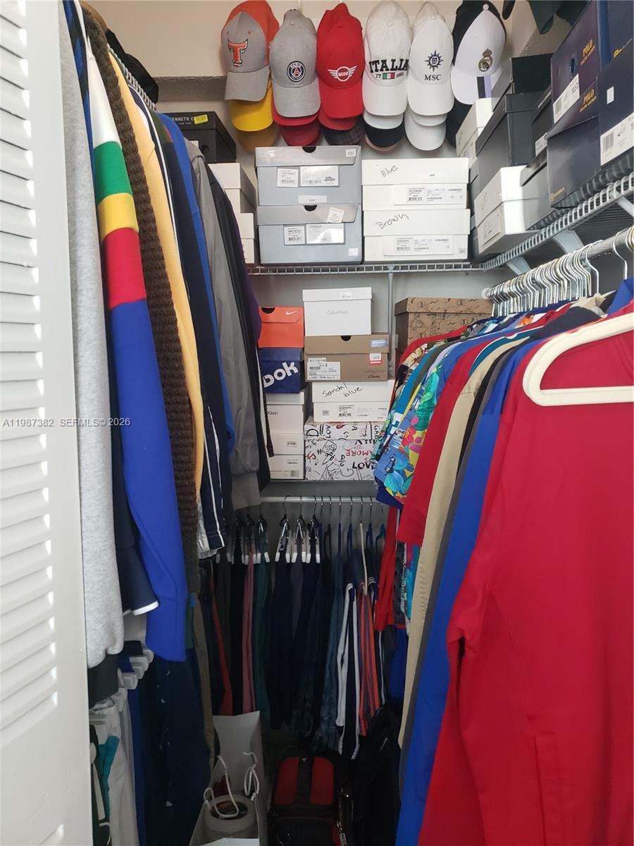 11800 Southwest 18th Street, Unit 3274 Miami, FL 33175 - Photo 22 of 23 a view of walk in closet with clothes and shoes
