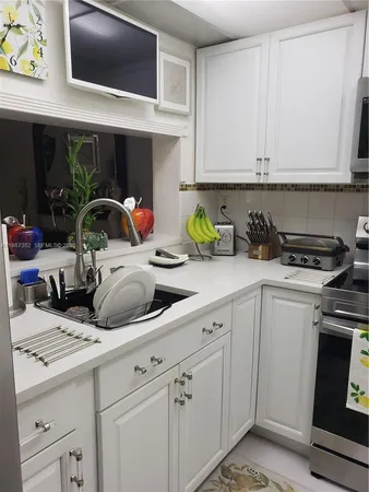 a kitchen with stainless steel appliances a stove a microwave and cabinets