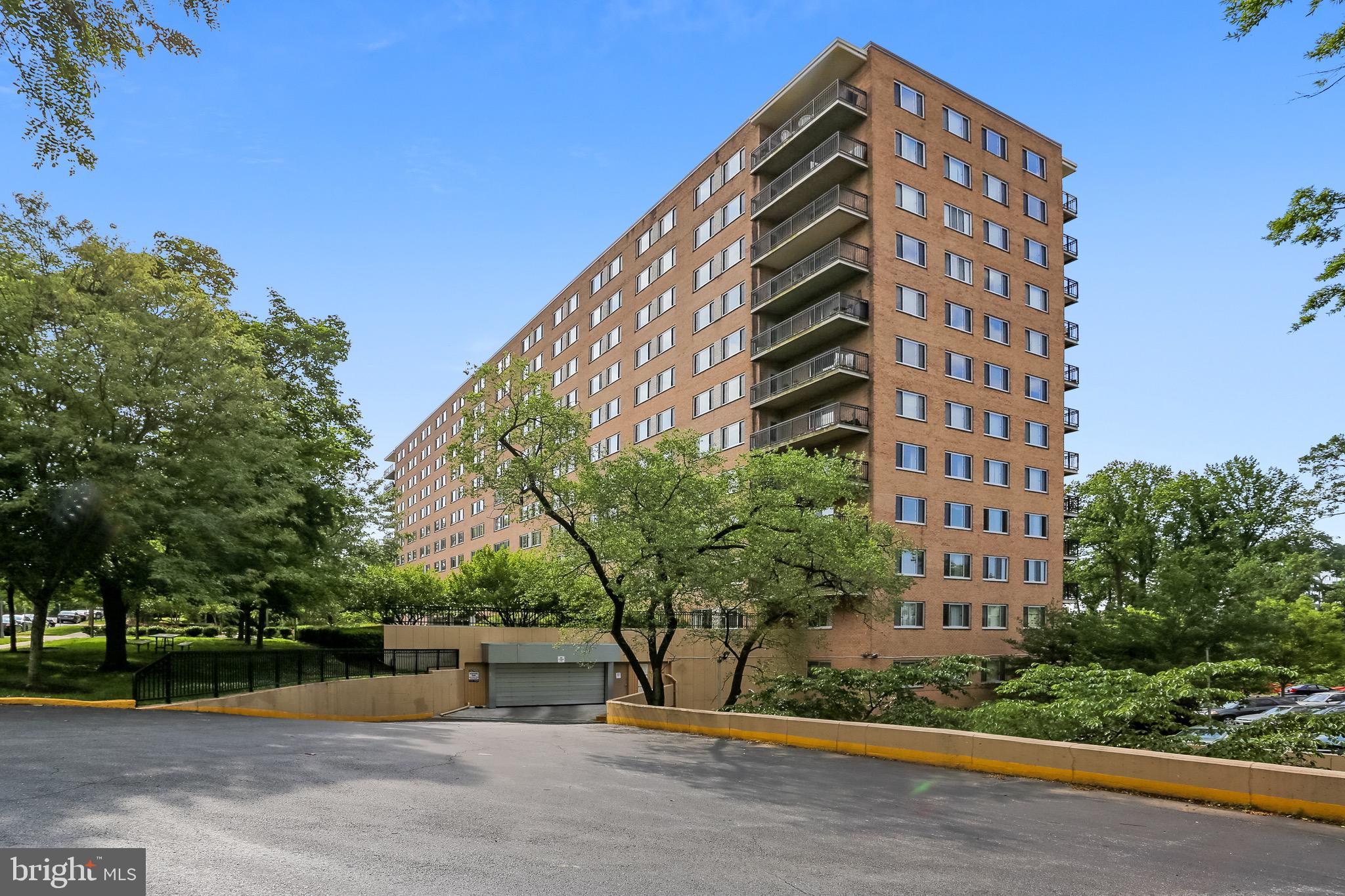 a view of a tall building next to a road