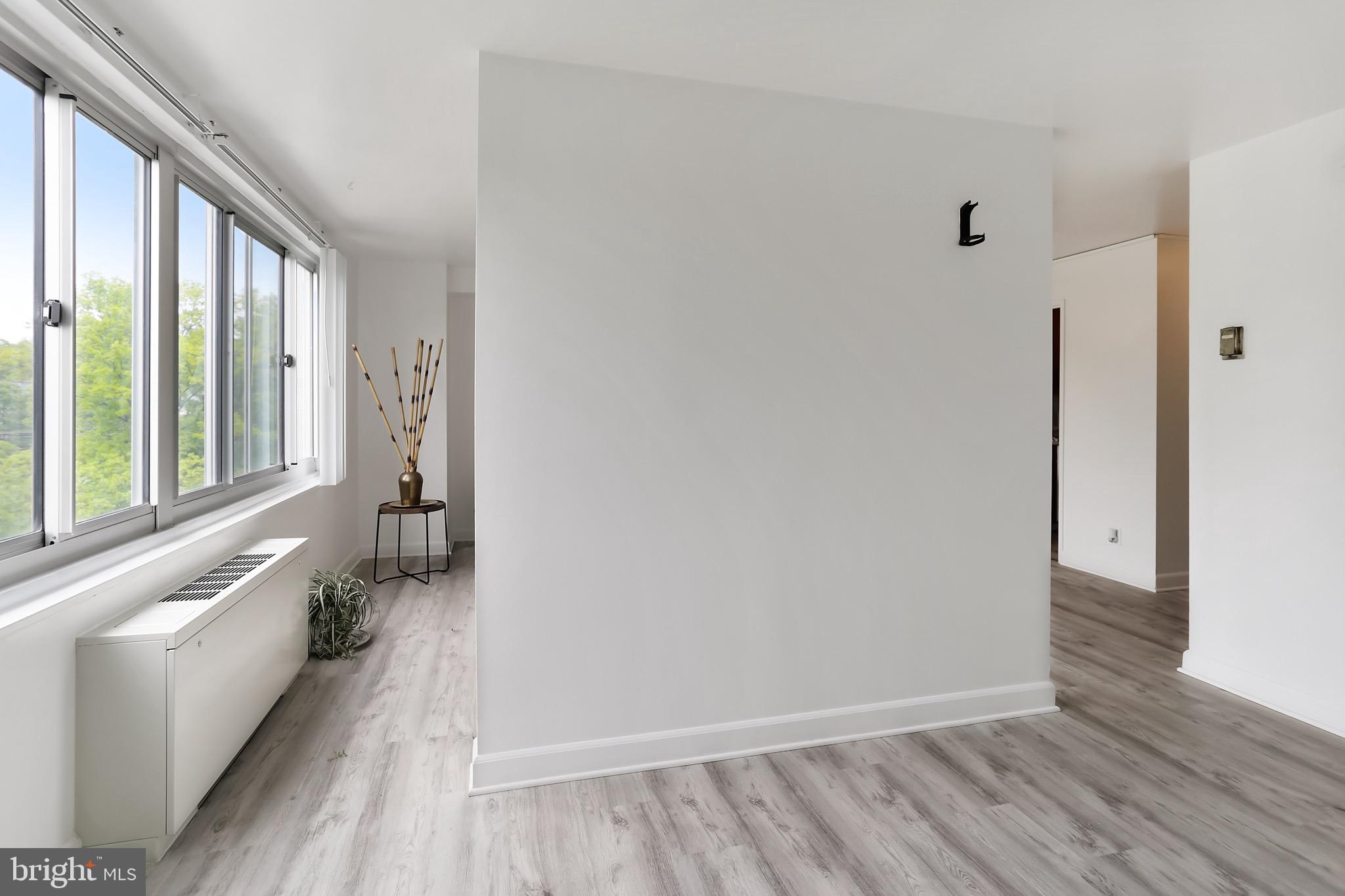 1900 Lyttonsville Road, Unit 802 Silver Spring, MD 20910 - Photo 24 of 38 a view of a room with wooden floor and windows