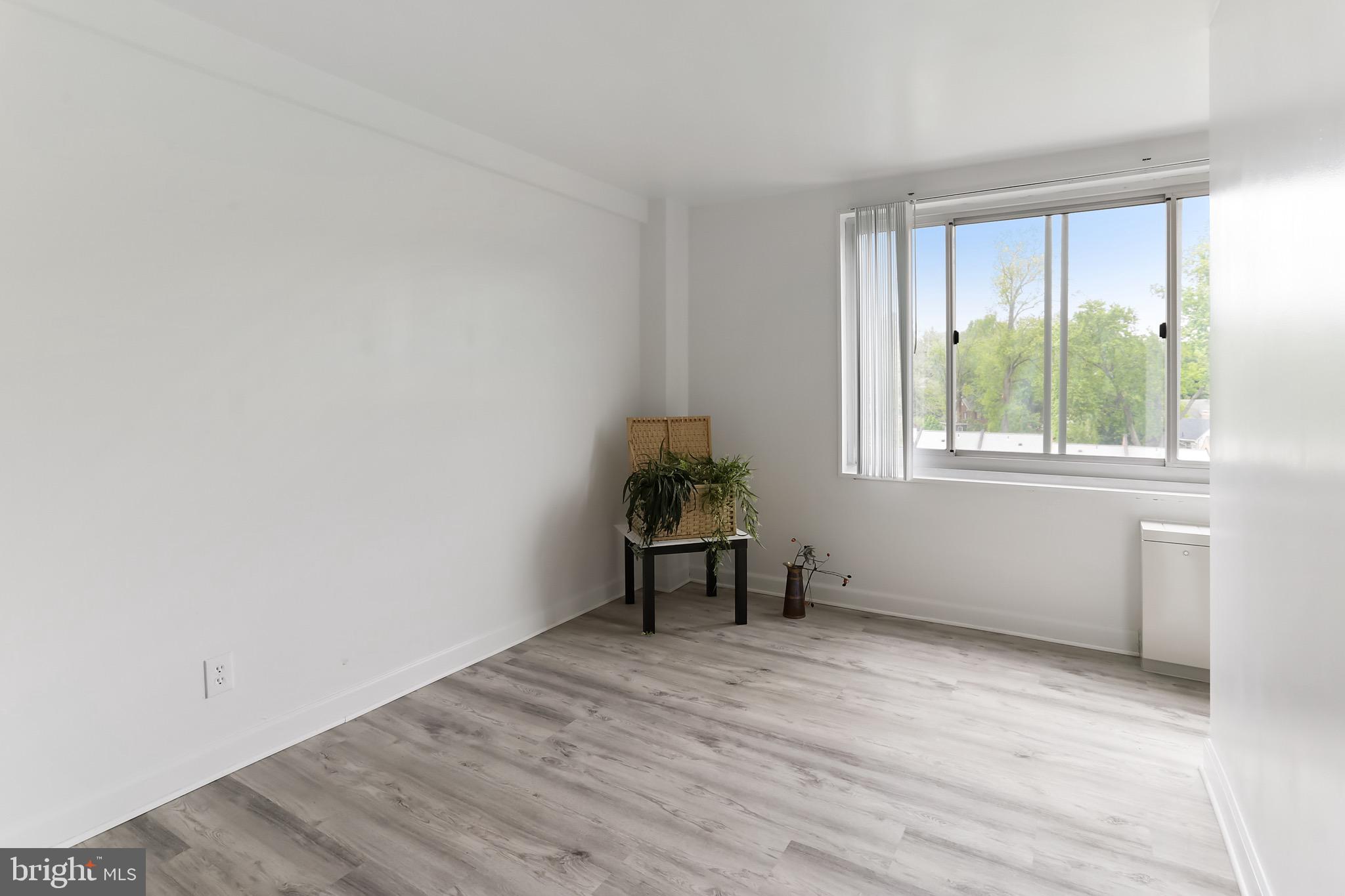 1900 Lyttonsville Road, Unit 802 Silver Spring, MD 20910 - Photo 26 of 38 a view of a livingroom with wooden floor and a window