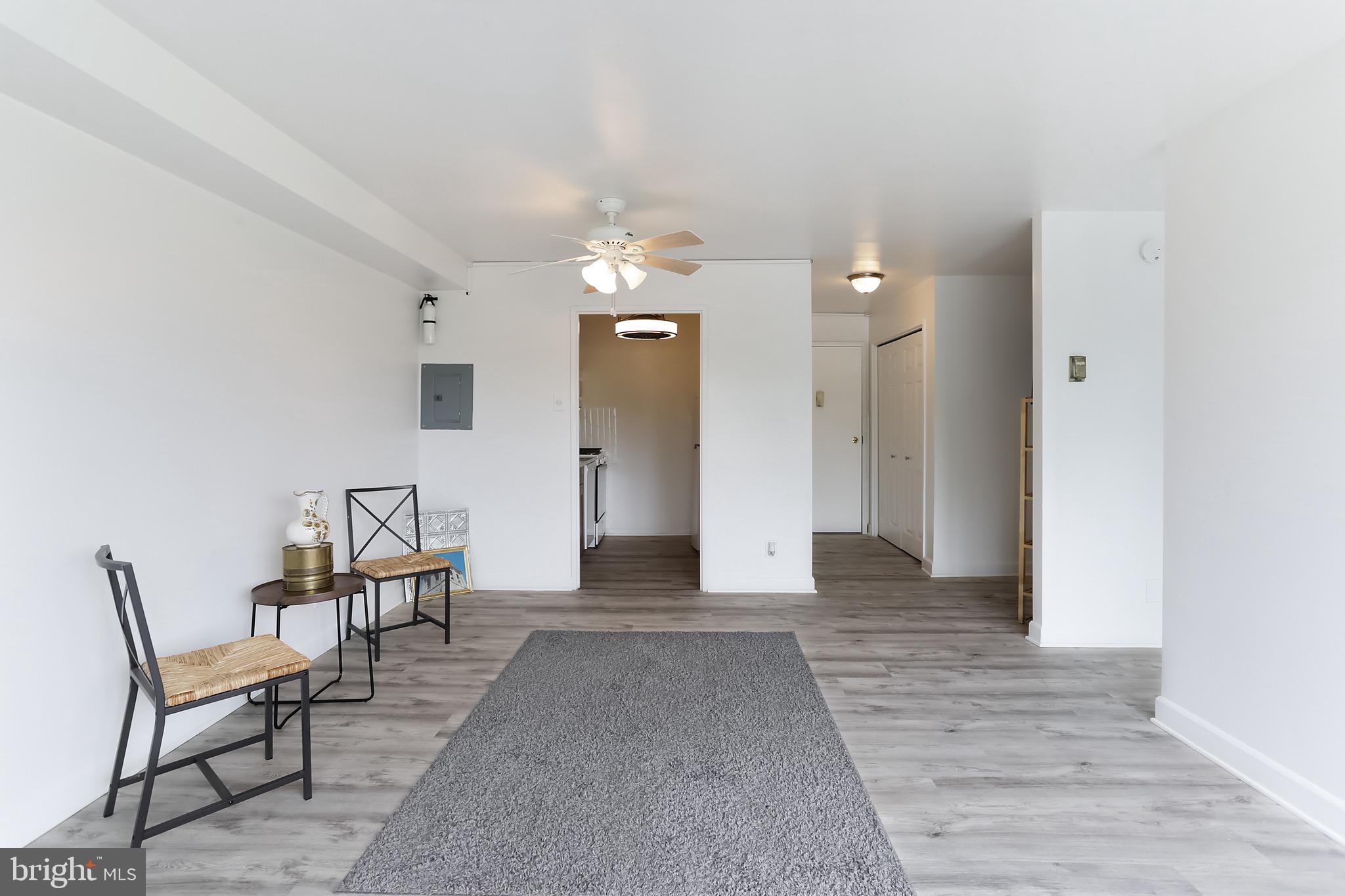 1900 Lyttonsville Road, Unit 802 Silver Spring, MD 20910 - Photo 28 of 38 a view of a livingroom with furniture and chandelier fan