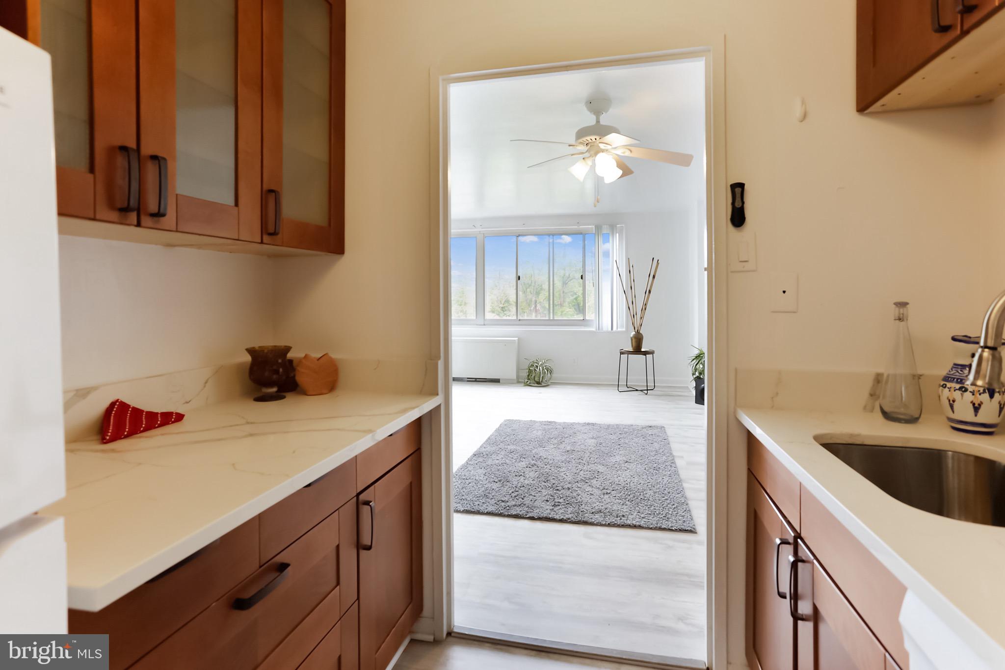1900 Lyttonsville Road, Unit 802 Silver Spring, MD 20910 - Photo 29 of 38 a en suite bathroom with a granite countertop sink and a mirror
