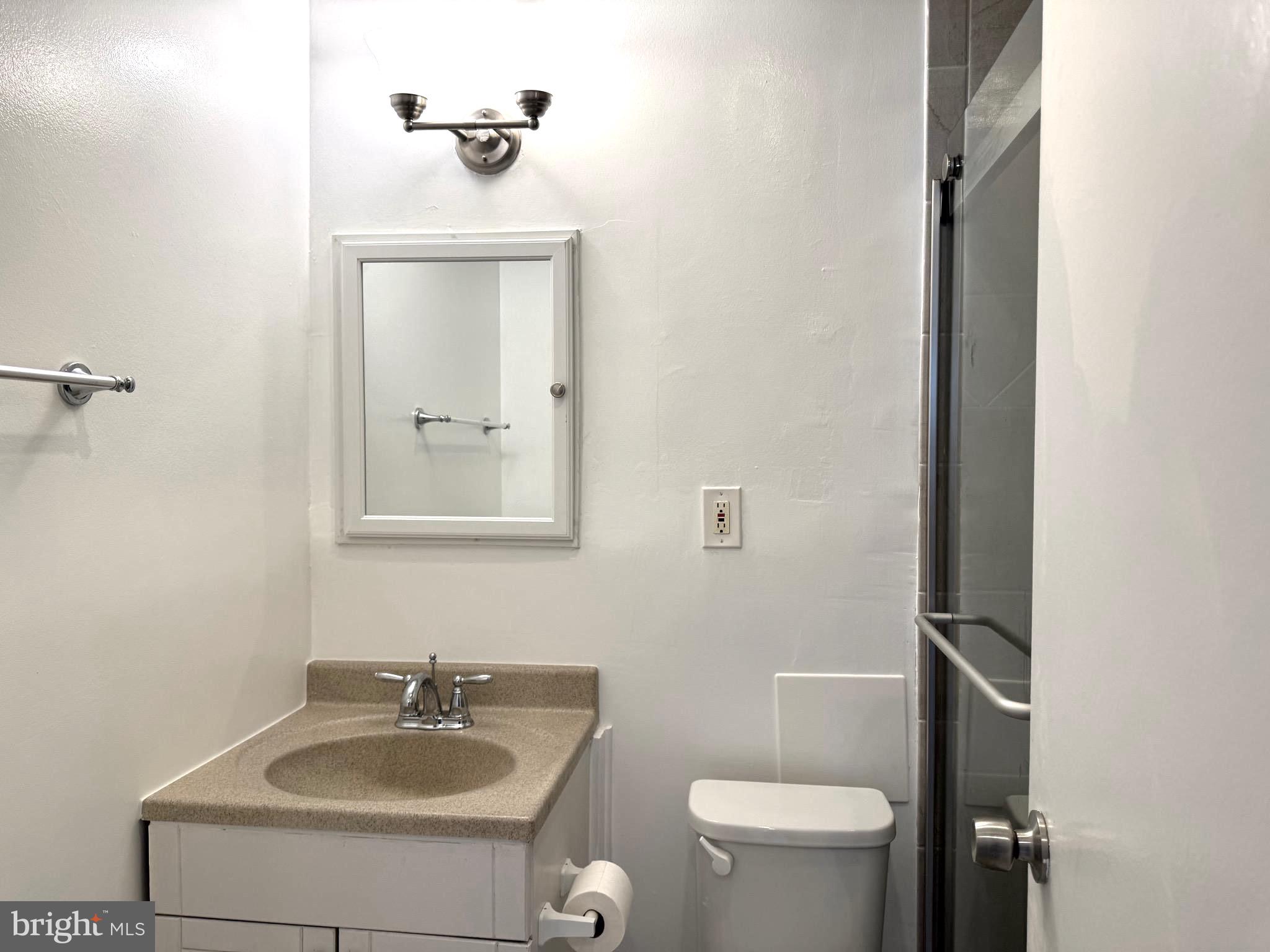 1900 Lyttonsville Road, Unit 802 Silver Spring, MD 20910 - Photo 34 of 38 a bathroom with a sink a toilet and mirror