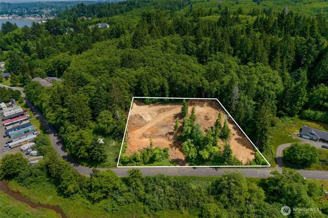 an aerial view of residential house with outdoor space and trees all around