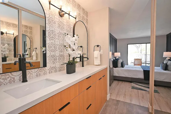 a large living room with stainless steel appliances kitchen island granite countertop furniture and a granite counter tops