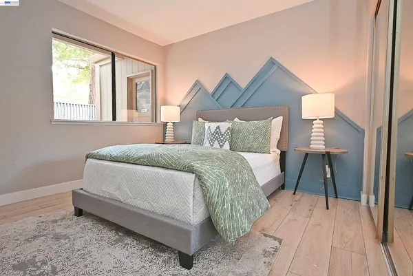 a bedroom with a bed and a night stand