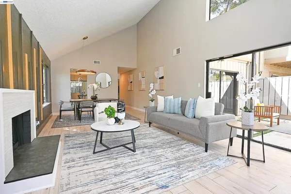 a living room with fireplace furniture and a wooden floor