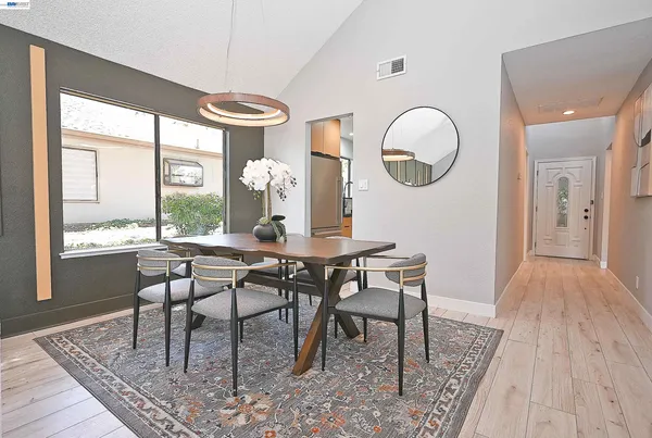 a view of a dining room with furniture window and wooden floor