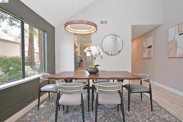 a dining room with furniture a window and a chandelier