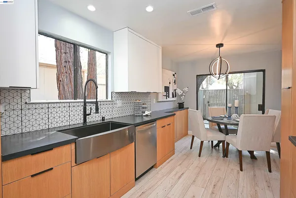 a kitchen with granite countertop a dining table chairs sink and granite counter tops